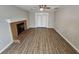 Bright living room with a cozy fireplace, wood-look flooring, and access to sliding doors for natural light at 200 Williamsburg Way, Fayetteville, GA 30214
