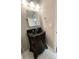 Bathroom sink with an ornate wooden cabinet, large mirror, and modern fixtures at 705 Windchase Ln, Stone Mountain, GA 30083