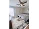 Bright bedroom featuring a comfortable bed, hardwood floors, and a ceiling fan with overhead lighting at 705 Windchase Ln, Stone Mountain, GA 30083