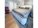 Spacious bedroom featuring a large bed with upholstered headboard, hardwood floors, and ample natural light at 705 Windchase Ln, Stone Mountain, GA 30083