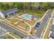 Aerial view of community featuring a swimming pool, greenery, walking path, and ample parking for residents at 823 Mackay Crk, Woodstock, GA 30188