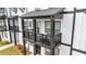 This townhome features a charming balcony with black railings and posts and an outdoor seating area at 823 Mackay Crk, Woodstock, GA 30188