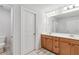 Bright bathroom featuring a double sink vanity with wood cabinets and white countertops at 823 Mackay Crk, Woodstock, GA 30188