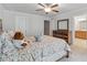 Neutral bedroom with a ceiling fan and wood furnishings at 823 Mackay Crk, Woodstock, GA 30188