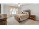 Cozy bedroom with neutral tones, a ceiling fan, and decorative curtains at 823 Mackay Crk, Woodstock, GA 30188