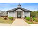 Welcoming community clubhouse with stylish architecture and landscaping leading to the neighborhood pool at 823 Mackay Crk, Woodstock, GA 30188