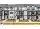 Modern townhome exteriors showcase black trim, balconies and manicured lawns at 823 Mackay Crk, Woodstock, GA 30188