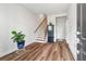 Inviting foyer with wood-look floors, staircase, and natural light at 823 Mackay Crk, Woodstock, GA 30188