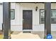 Classic black front door framed by sidelight windows and black columns at 823 Mackay Crk, Woodstock, GA 30188