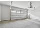 Spacious two-car garage featuring an automatic garage door opener and concrete floor at 823 Mackay Crk, Woodstock, GA 30188