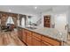 A kitchen island features granite counters, stainless steel appliances, and views into the living area at 823 Mackay Crk, Woodstock, GA 30188