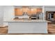Modern kitchen island with granite countertops, wood cabinets, and stainless appliances at 823 Mackay Crk, Woodstock, GA 30188