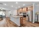 Open kitchen with granite counters, stainless steel appliances, and wood cabinetry at 823 Mackay Crk, Woodstock, GA 30188