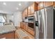 Well-equipped kitchen with stainless steel appliances, granite countertops, and wood cabinets at 823 Mackay Crk, Woodstock, GA 30188