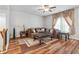 Open living room showcasing hardwood floors, a ceiling fan, and decorative curtains at 823 Mackay Crk, Woodstock, GA 30188
