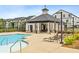Community pool and clubhouse with lounge chairs for relaxing on a sunny day at 823 Mackay Crk, Woodstock, GA 30188