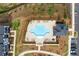 Aerial view showing a uniquely-shaped pool surrounded by lounge chairs and landscaping in the community at 823 Mackay Crk, Woodstock, GA 30188