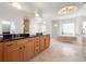 Spacious bathroom featuring double vanity, granite counters, tile floor, and luxurious soaking tub at 1159 Thornwell Ne Dr, Brookhaven, GA 30319