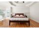 Bedroom featuring hardwood floors, tray ceilings, crown molding, recessed lighting and a large window at 1159 Thornwell Ne Dr, Brookhaven, GA 30319