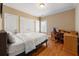 Cozy bedroom offers a desk, chair, two closets, wood floors, and a window allowing for natural light to fill the room at 1159 Thornwell Ne Dr, Brookhaven, GA 30319