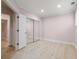 Cozy bedroom with mirrored closet doors and wood-look flooring at 1159 Thornwell Ne Dr, Brookhaven, GA 30319