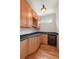 Butlers pantry with custom cabinets, wine rack, dark countertops and wine cooler at 1159 Thornwell Ne Dr, Brookhaven, GA 30319
