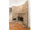Close up of the stone fireplace with decorative details and hardwood floors in the living room at 1159 Thornwell Ne Dr, Brookhaven, GA 30319