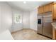 Bright kitchen area with stainless steel refrigerator and door to backyard at 1159 Thornwell Ne Dr, Brookhaven, GA 30319