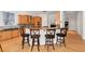 Well-equipped kitchen with a granite-topped breakfast bar, wooden cabinetry, and stainless steel appliances at 1159 Thornwell Ne Dr, Brookhaven, GA 30319