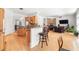 Spacious open floor plan with a kitchen featuring stainless steel appliances and a stone fireplace in the living room at 1159 Thornwell Ne Dr, Brookhaven, GA 30319