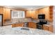 Bright kitchen featuring granite countertops, stainless steel appliances, and light wood cabinetry at 1159 Thornwell Ne Dr, Brookhaven, GA 30319