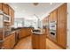 Well-lit kitchen features wood cabinets, granite countertops, stainless steel appliances and a kitchen island with a gas cooktop at 1159 Thornwell Ne Dr, Brookhaven, GA 30319