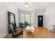 Comfortable living room with hardwood floors, large windows, and stylish seating at 1159 Thornwell Ne Dr, Brookhaven, GA 30319
