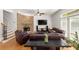 Inviting living room with a stone fireplace, hardwood floors, and comfortable leather furniture at 1159 Thornwell Ne Dr, Brookhaven, GA 30319