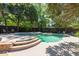 Private backyard pool and spa surrounded by lush greenery and mature trees at 1159 Thornwell Ne Dr, Brookhaven, GA 30319