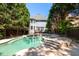 Beautiful in-ground pool with a spa, steps, and outdoor deck in a private backyard setting at 1159 Thornwell Ne Dr, Brookhaven, GA 30319