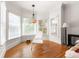 Cozy sitting area featuring three large windows, hardwood floors, crown molding, and a hanging chandelier at 1159 Thornwell Ne Dr, Brookhaven, GA 30319
