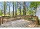 Back deck is perfect for outdoor enjoyment surrounded by mature trees on a sunny day at 2965 Carrie Farm Nw Rd, Kennesaw, GA 30144
