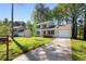 Two-story home featuring a front yard, a driveway and an attached garage in a lush setting at 2965 Carrie Farm Nw Rd, Kennesaw, GA 30144