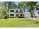Charming two-story home with a well-maintained lawn, a red front door and lush landscaping at 2965 Carrie Farm Nw Rd, Kennesaw, GA 30144
