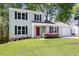Charming two-story home with a well-maintained lawn, a red front door and lush landscaping at 2965 Carrie Farm Nw Rd, Kennesaw, GA 30144