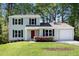 Charming two-story home with a well-maintained lawn, a red front door and lush landscaping at 2965 Carrie Farm Nw Rd, Kennesaw, GA 30144