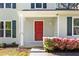 Inviting front entrance featuring a red door, white trim and beautiful flowering bushes at 2965 Carrie Farm Nw Rd, Kennesaw, GA 30144