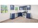 Stylish kitchen with navy blue cabinetry, stainless steel appliances, and bright lighting at 2965 Carrie Farm Nw Rd, Kennesaw, GA 30144