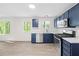 Stylish kitchen with navy blue cabinetry, stainless steel appliances, and bright lighting at 2965 Carrie Farm Nw Rd, Kennesaw, GA 30144