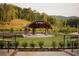 Inviting outdoor amphitheater with a covered stage, seating, and beautifully landscaped surroundings at 625 Skytop Dr, Cumming, GA 30040