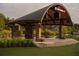 Outdoor covered amphitheater stage with stone pillars and lush green lawn area at 625 Skytop Dr, Cumming, GA 30040