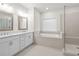 Bright bathroom features double vanity, soaking tub, and glass-enclosed shower at 625 Skytop Dr, Cumming, GA 30040