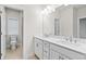 Well-lit bathroom with double sinks, granite countertops, and modern fixtures at 625 Skytop Dr, Cumming, GA 30040