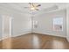 Spacious bedroom with tray ceilings, hardwood floors, and large windows at 625 Skytop Dr, Cumming, GA 30040